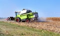 Harvesting corn with a combine in season and unloading grain into a truck, agricultural process