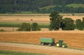 Harvesting of field in Austria countryside Royalty Free Stock Photo
