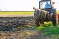 After harvesting the field in autumn, the tractor ploughs its way through it