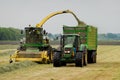 Harvesting grass, two tractors working Royalty Free Stock Photo