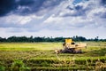 Harvesting machine at padi field Royalty Free Stock Photo