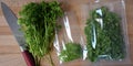 Harvesting parsley leaves for the winter and packing with plastic bags. Greens on a cutting board