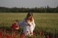 Young woman harvesting poppy