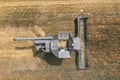 Harvesting in progress. Aerial view of black combine harvester harvesting wheat in field. Royalty Free Stock Photo