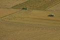 Harvester and tractor harvesting rice fields Royalty Free Stock Photo