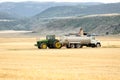 Offloading freshly harvested wheat into a truck. Royalty Free Stock Photo