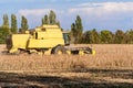 Harvesting of soybean field with combine harvester. Royalty Free Stock Photo