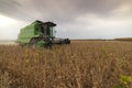 Agricultural machine harvesting soybean field Royalty Free Stock Photo