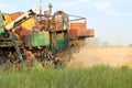 Harvesting in Ukraine combine harvester mows wheat in the field Royalty Free Stock Photo