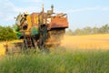 Harvesting in Ukraine combine harvester mows wheat in the field Royalty Free Stock Photo