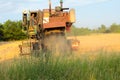 Harvesting in Ukraine combine harvester mows wheat in the field Royalty Free Stock Photo