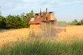 Harvesting in Ukraine combine harvester mows wheat in the field Royalty Free Stock Photo