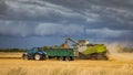 Harvesting under a very stormy looking sky. Royalty Free Stock Photo