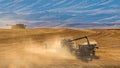 Harvesting the Wheat in a Dusty Field Royalty Free Stock Photo