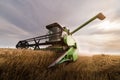 Harvesting of wheat field with combine Royalty Free Stock Photo