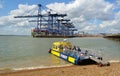 Harwich to Felixstowe and Shotley ferry takes up to twelve people across the busy estuary, port of Felixstowe in background.