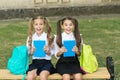 She has as many books as I. Happy bookworms outdoors. Little children hold school books. Library books. School and Royalty Free Stock Photo