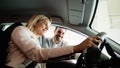 She has bought her dream car. Young woman sitting at the front seat of the car