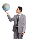 He has the business world at his fingertips. A handsome young executive holding a globe while isolated on a white