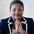 She has a clear vision of business. Portrait of a smiling young businesswoman sitting in an office. Royalty Free Stock Photo