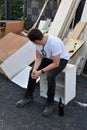 After he has done his work teenage boy sits in the bulky refuse