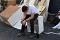 After he has done his work teenage boy sits in the bulky refuse