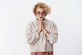 She has faith. Portrait of determined attractive stylish hipster girl with short curly haircut in glasses and sweater