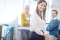 She has a great team behind her. Portrait of an attractive young brunette businesswoman with her colleagues in the Royalty Free Stock Photo