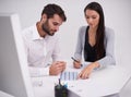 She has a keen eye for business. two young business colleagues discussing documents in the office.