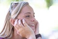 She has a sunny disposition. A beautiful young woman looking away nostalgically while outdoors.