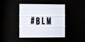 Hashtag BLM BLACK LIVES MATTER text on a black background. Freedom of Speech Vintage Retro quote board. Protest against the end of