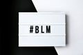 Hashtag BLM BLACK LIVES MATTER text on a black and white background. Freedom of Speech Vintage Retro quote board. Protest against