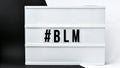 Hashtag BLM BLACK LIVES MATTER text on a black and white background. Freedom of Speech Vintage Retro quote board. Protest against