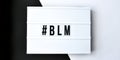 Hashtag BLM BLACK LIVES MATTER text on a black and white background. Freedom of Speech Vintage Retro quote board. Protest against