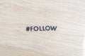 a hashtag follow, web internet like and share buttons, cut letters word, flat lay