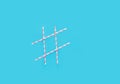 Hashtag sign made from striped pink and white paper drinking straws on light blue background. Birthday party celebration fun Royalty Free Stock Photo