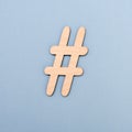 Hashtag sign made of wooden material on blue background Royalty Free Stock Photo