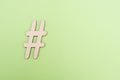 Hashtag sign made of wooden material on green background Royalty Free Stock Photo