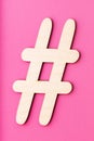 Hashtag sign made of wooden material on pink background Royalty Free Stock Photo