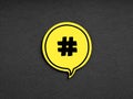 Hashtag symbol on yellow speech bubble on black background. Social media network marketing communication concept Royalty Free Stock Photo