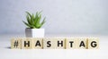 Hashtag word wooden cubes on blue background