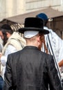 Hasid in a traditional hat on the street in a crowd of pilgrims. Rosh Hashanah, Jewish New Year.