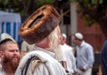 Hasid in the traditional headgear shtreimel on the street in a crowd of pilgrims. Rosh Hashanah, Jewish New Year