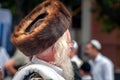 Hasid in the traditional headgear shtreimel on the street in a crowd of pilgrims. Rosh Hashanah, Jewish New Year