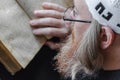 A Hasidic Jew reads Siddur. Religious orthodox Jew with a red beard and with pace in a white bale praying. Closeup Royalty Free Stock Photo