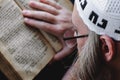 A Hasidic Jew reads Siddur. Religious orthodox Jew with a red beard and with pace in a white bale praying. Closeup Royalty Free Stock Photo