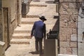 Hasidic Jewish man looking in bin in Jerusalem`s Jewish Quarter