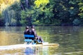 2 Hasidic Jews ride a catamaran on the lake in the autumn Park in Uman, Ukraine, during the Jewish New Year