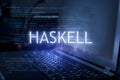 Haskell inscription against laptop and code background. Technology concept. Learn programming language