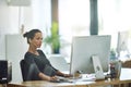 She hasnt gone on maternity leave just yet. a pregnant businesswoman working on her computer in the office. Royalty Free Stock Photo